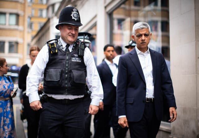 <p>Sir Sadiq Khan speaks with police officers in the West End of London (James Manning/PA)</p>