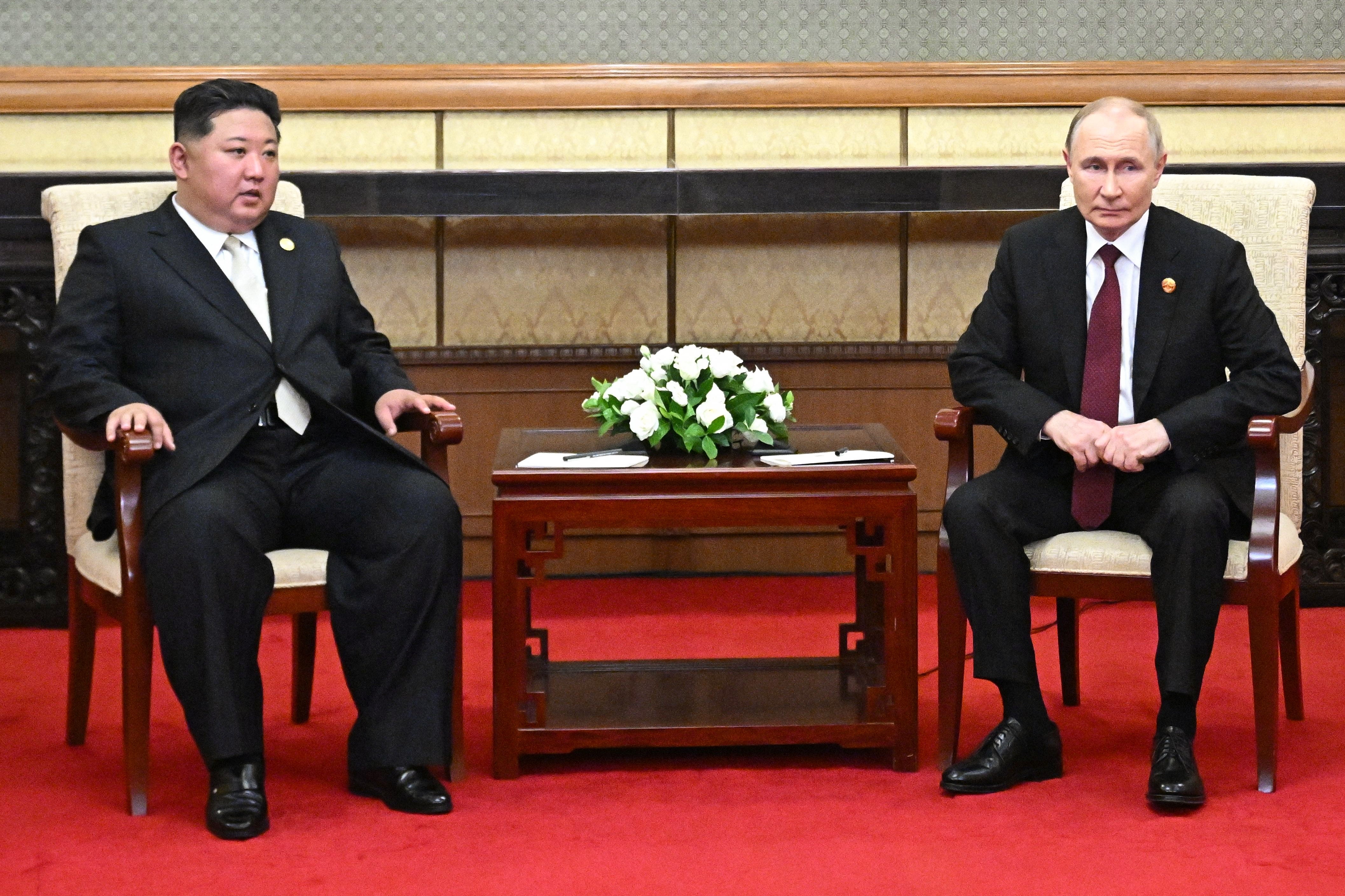 Russian president Vladimir Putin (2nd-R) and North Korean leader Kim Jong Un (2nd-L) meet after attending a military parade marking the 80th anniversary of victory over Japan and the end of World War II