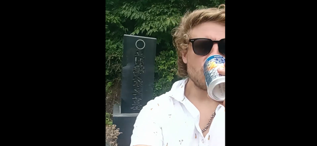 <p>Australian tourist Lochie Jones drinks a grave offering in Japan</p>