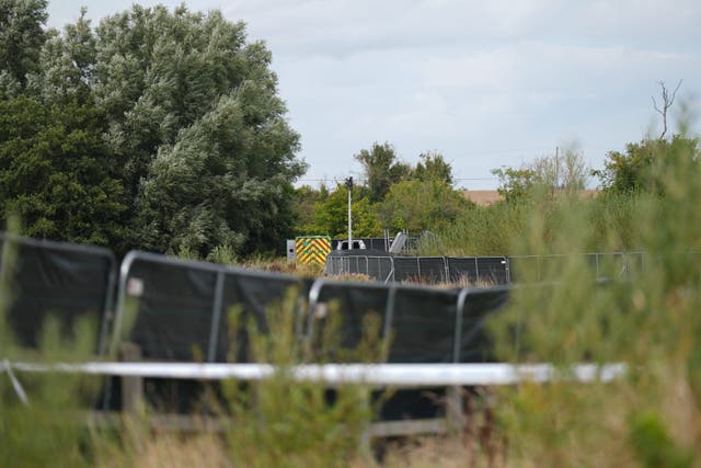 Gardai on an area of open ground in Donabate (Niall Carson/PA)