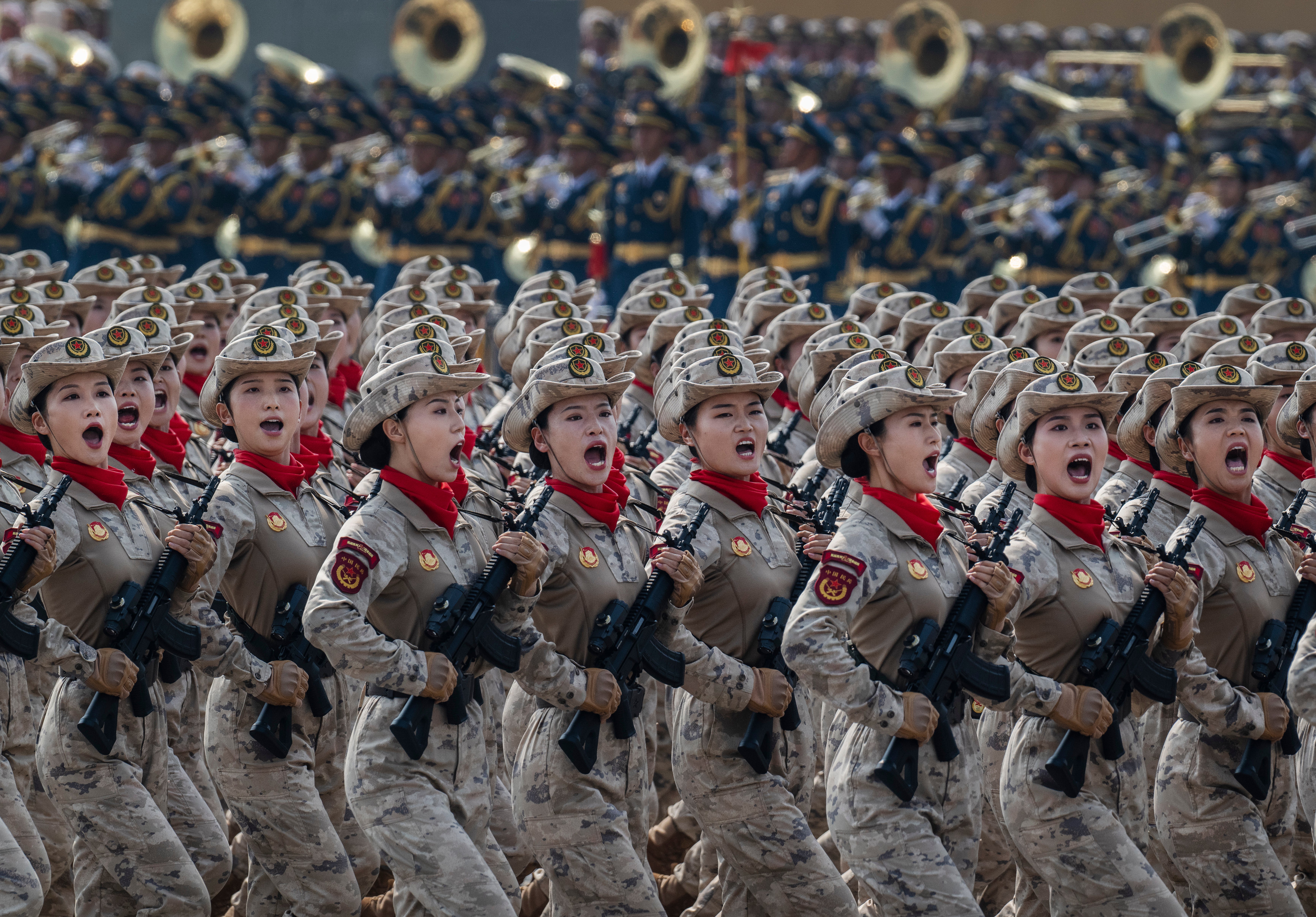 Hundreds of women take part in the parade to mark 80 years since victory over Japan