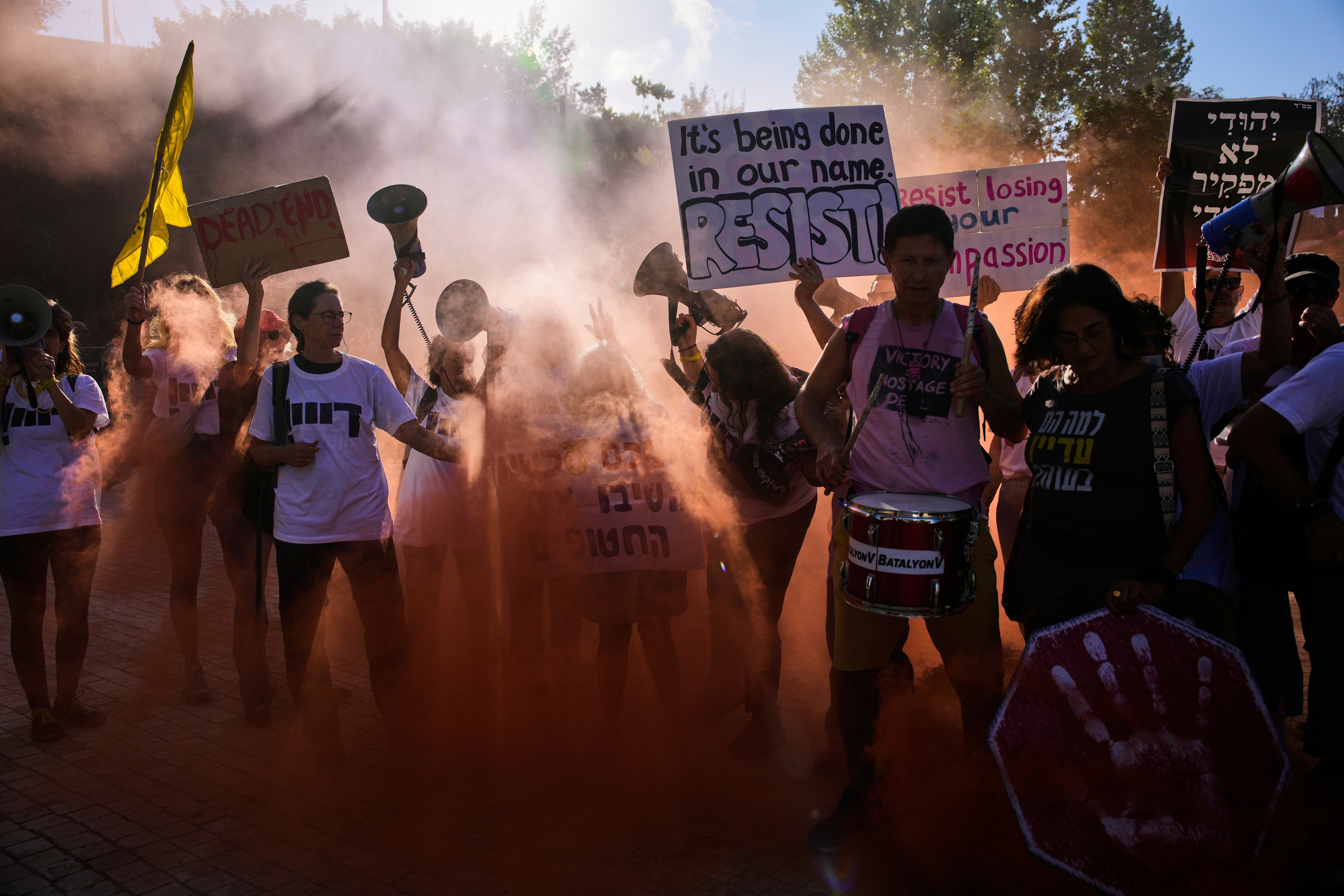 Demonstrators wave signs and shout slogans calling for the end of the war in the Gaza Strip, in Jerusalem, Wednesday, Sept. 3, 2025. (AP Photo/Ohad Zwigenberg)