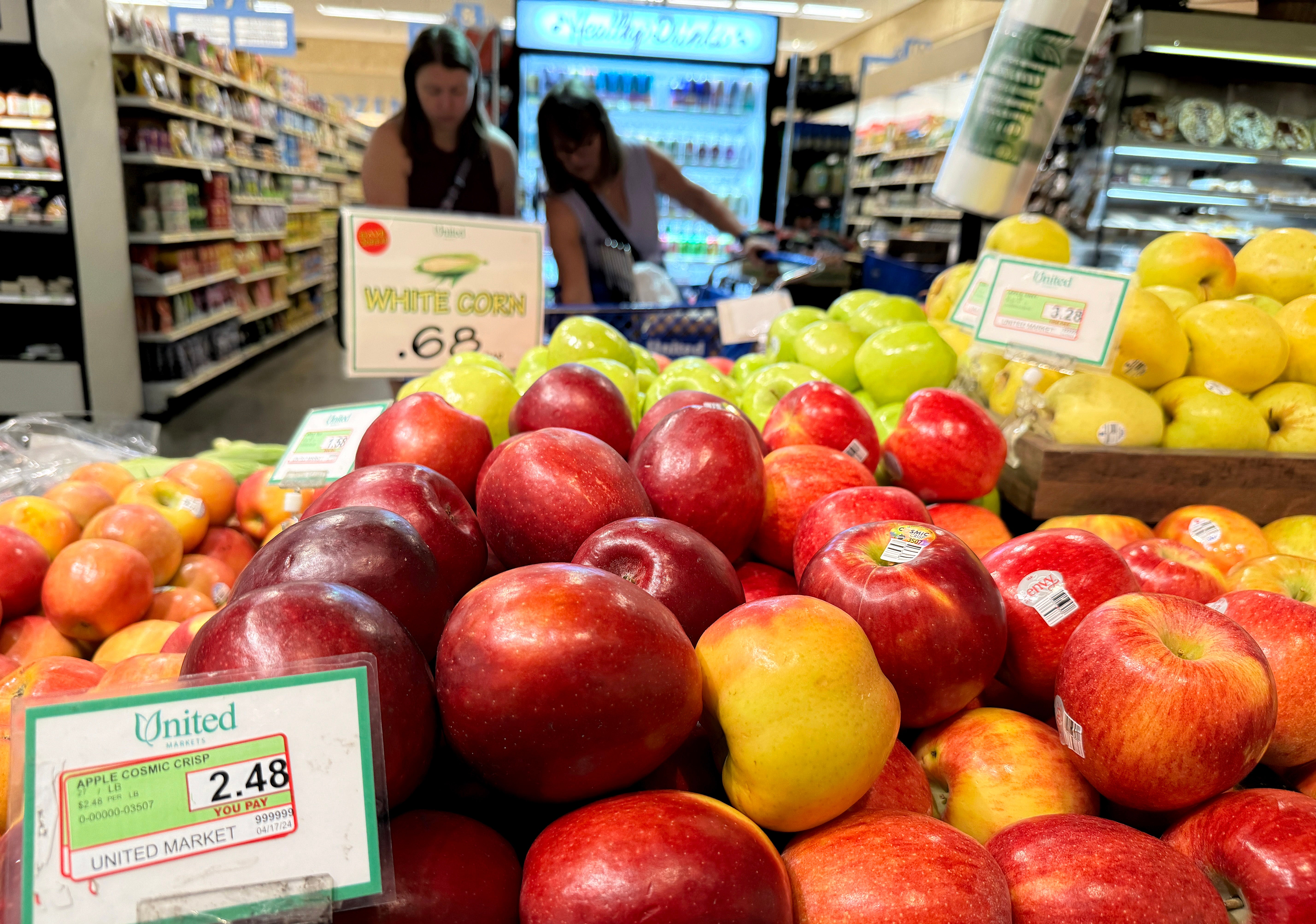 People shop at a San Anselmo, California, grocery store where apples are displayed last June. Eating apples has been tied to lower blood pressure