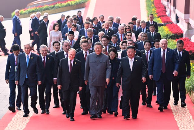 <p>Chinese president Xi Jinping, center, and foreign leaders including Russia president Vladimir Putin, center left, and North Korean leader Kim Jong Un, center right, walk to Tiananmen Rostrum</p>