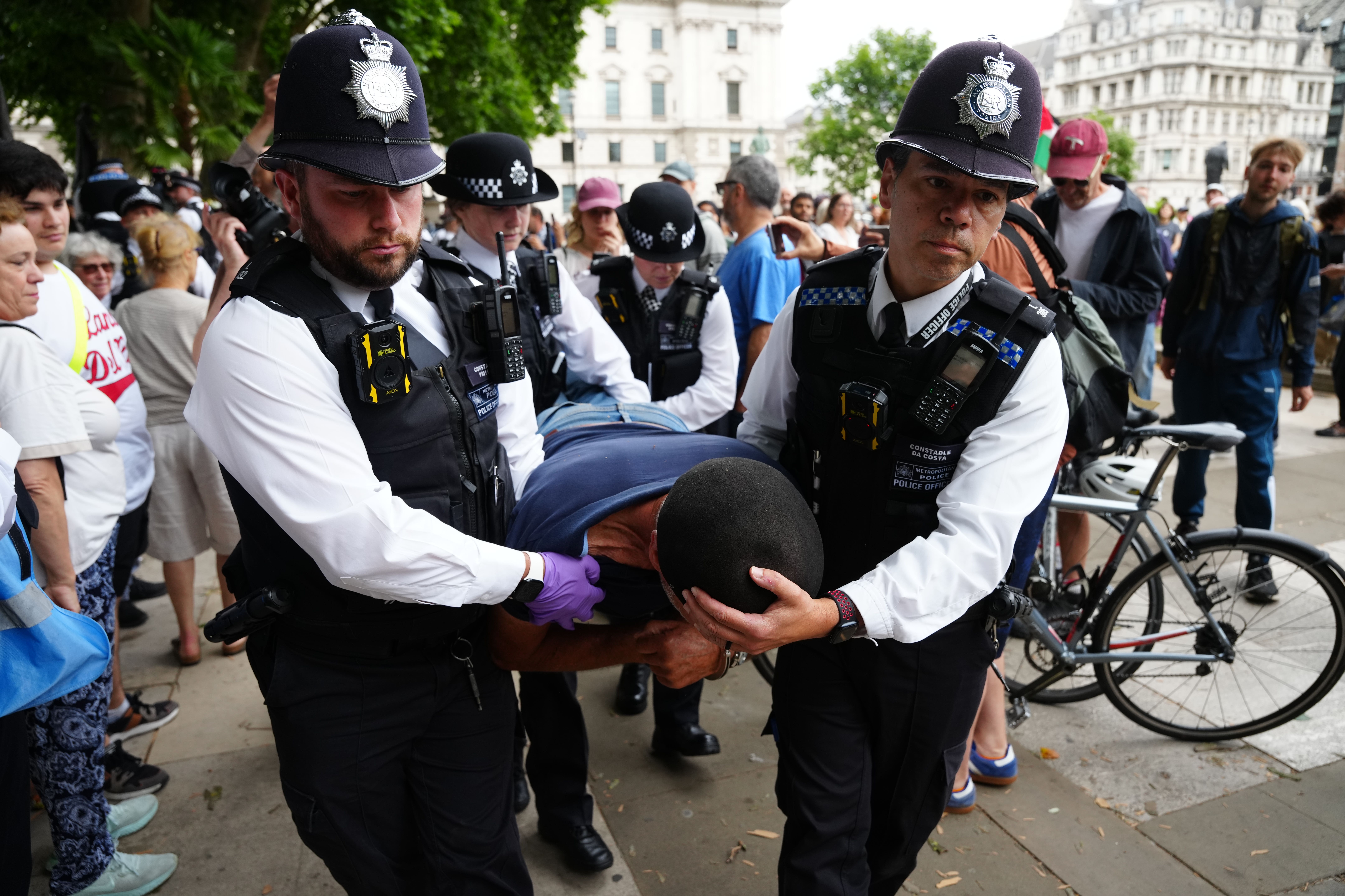 A protester is carried away at an earlier demonstration in July (Jeff Moore/PA Wire)