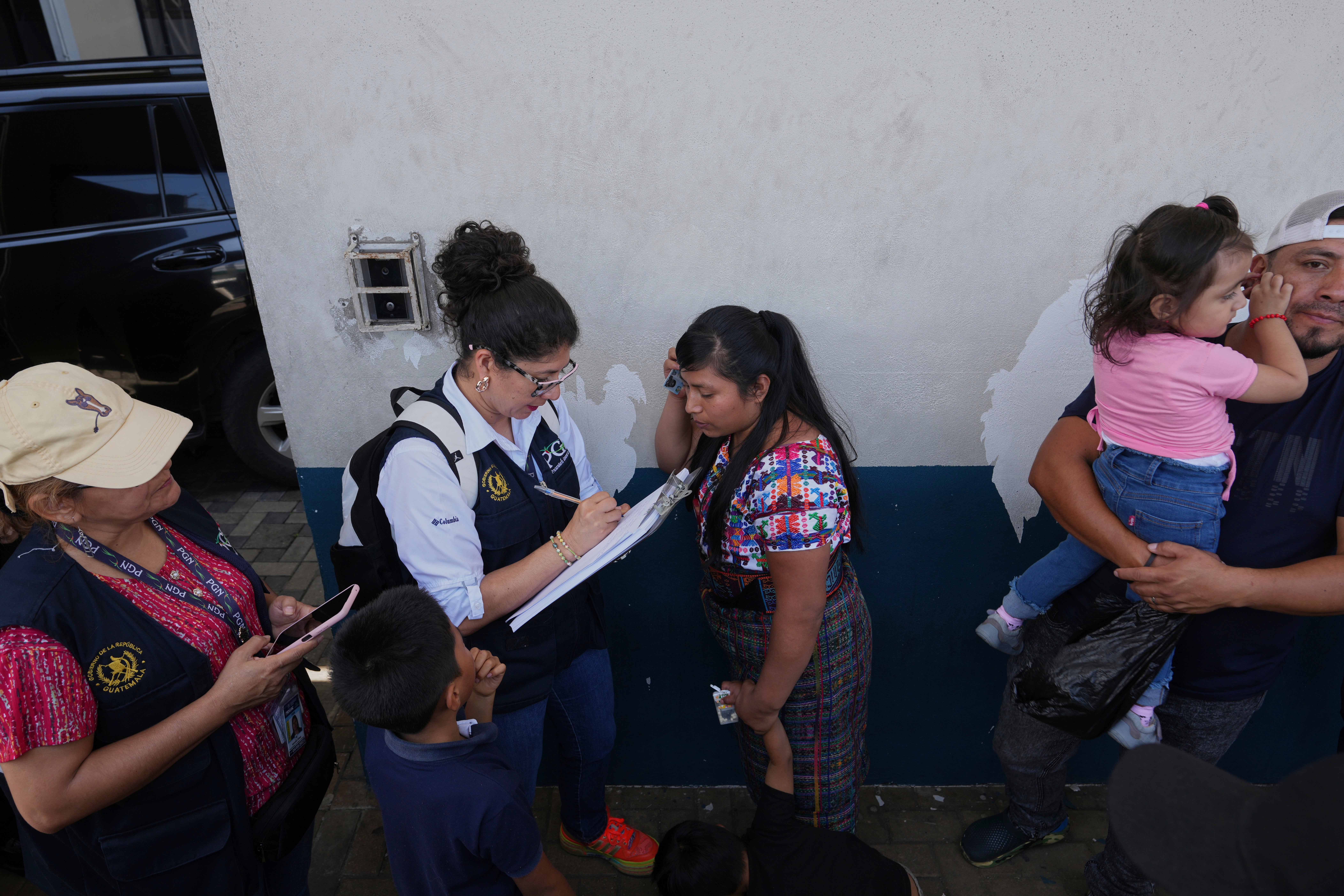 Relatives of unaccompanied minors deported from the United States await updates outside La Aurora International Airport, in Guatemala City August 31. In court filings, lawyers and children described how they were abruptly packed into buses and placed on planes before a judge blocked their removal