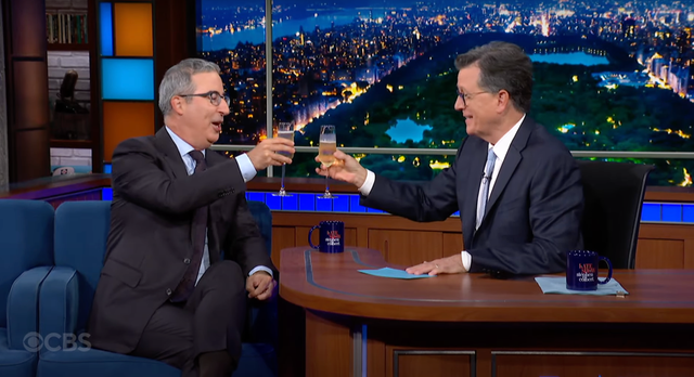 <p>John Oliver and Stephen Colbert raise a toast to late-night shows</p>