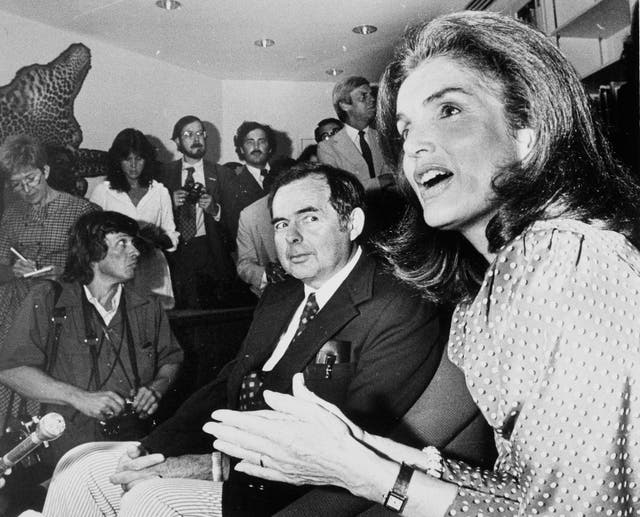 <p>Patrick Hemingway, center, watches as Jacqueline Kennedy Onassis, right, talks to reporters at ceremonies marking the opening of the Ernest Hemingway Room at the John F. Kennedy Memorial Library in Boston, July 18, 1980</p>