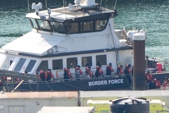 A group of people thought to be migrants are brought ashore in August in Dover from a Border Force vessel (Gareth Fuller/PA)