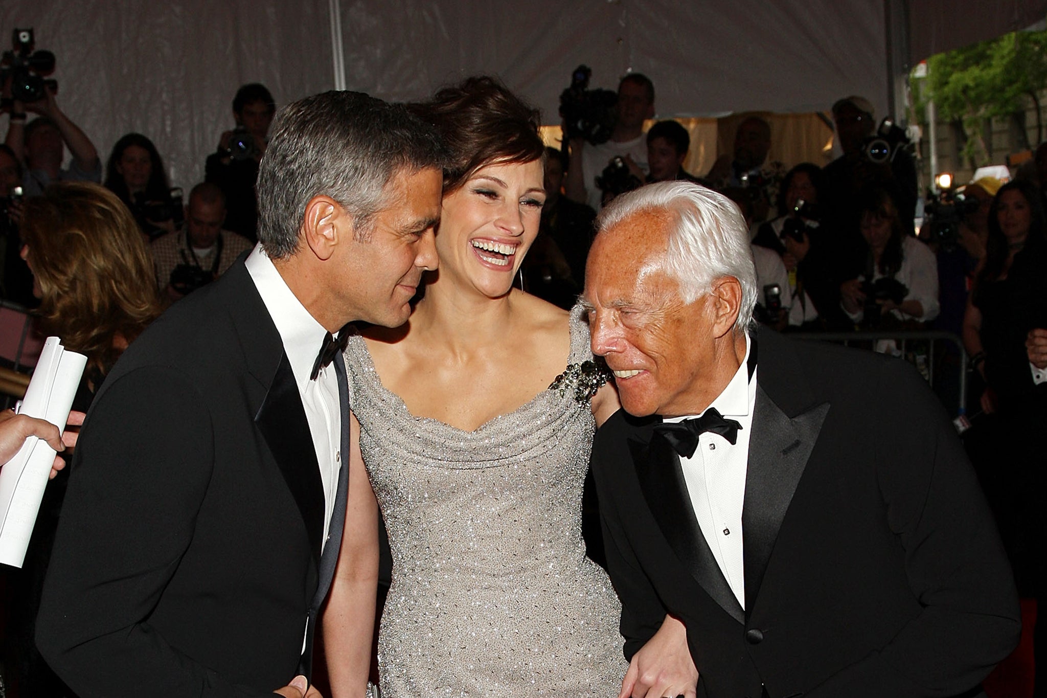 George Clooney and Julia Roberts pictured with Armani as they arrive at the Metropolitan Museum of Art Costume Institute Gala in May 2005