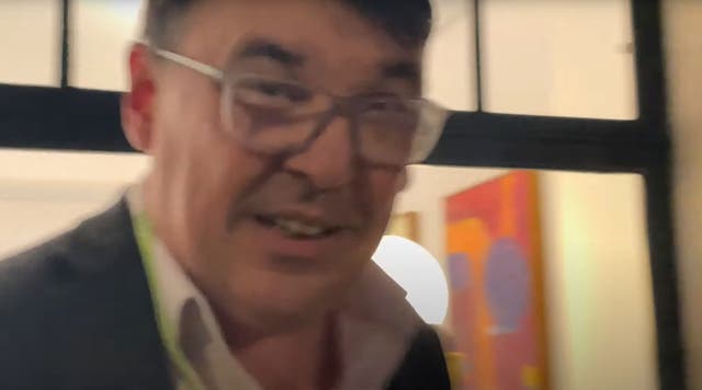 <p>A grab from a video played to the court appearing to show Graham Linehan grabbing the complainant’s phone</p>