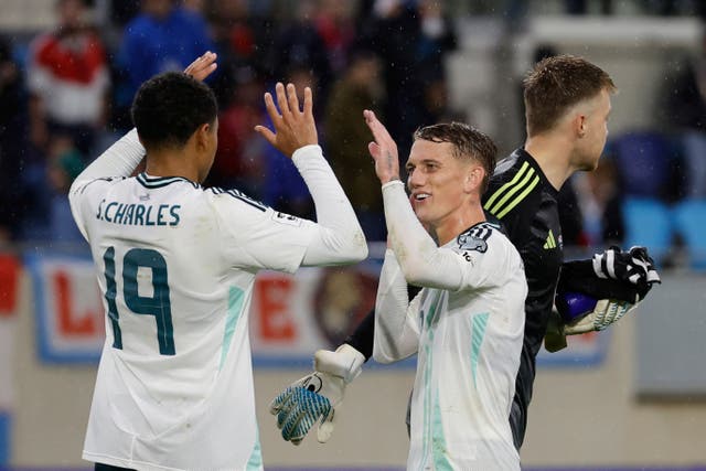 Northern Ireland’s Ethan Galbraith, right, celebrates with team-mate Shea Charles (Geert Vanden Wijngaert/AP)