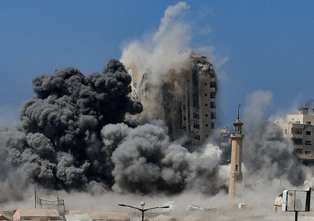 <p>Smoke rises as a building is hit by an Israeli strike in Gaza City</p>
