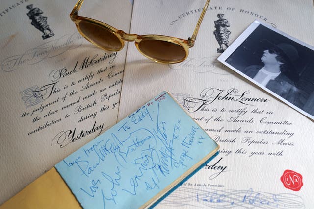 A pair of 1966 Ivor Novello certificates for ‘Yesterday’ awarded to Paul McCartney and John Lennon accompanied by a pair of 1970s sunglasses purported to have belonged to John Lennon, an autograph book featuring signatures for the Beatles, Rolling Stones and other artists and a collection of black and white 1960s photographs of various artists including The Beatles, Rolling Stones, Sony & Cher, Bowie, Bob Dylan on display ahead a the sale of rock and roll memorabilia at Catherine Southon Auctioneers & Valuers, in Chislehurst later this month. Picture date: Tuesday September 2, 2025.