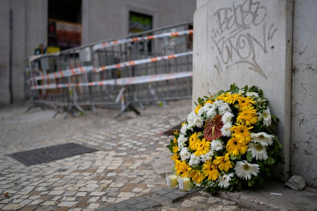 <p>Flowers are placed at the site where a tourist streetcar derailed and crashed in Lisbon </p>