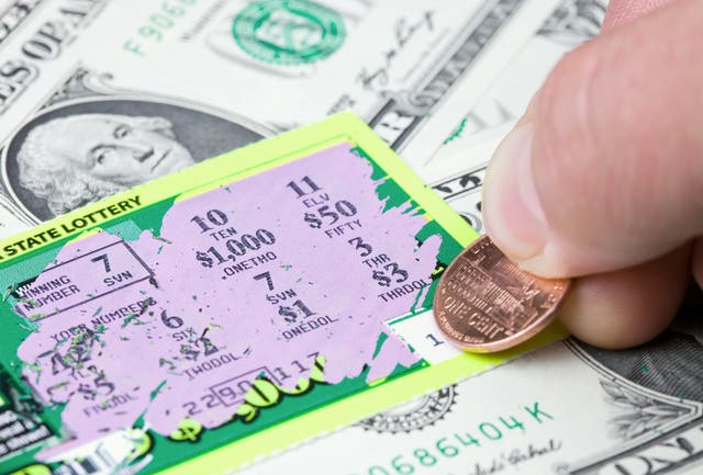 <p>A lottery player has scratched a winning ticket</p>
