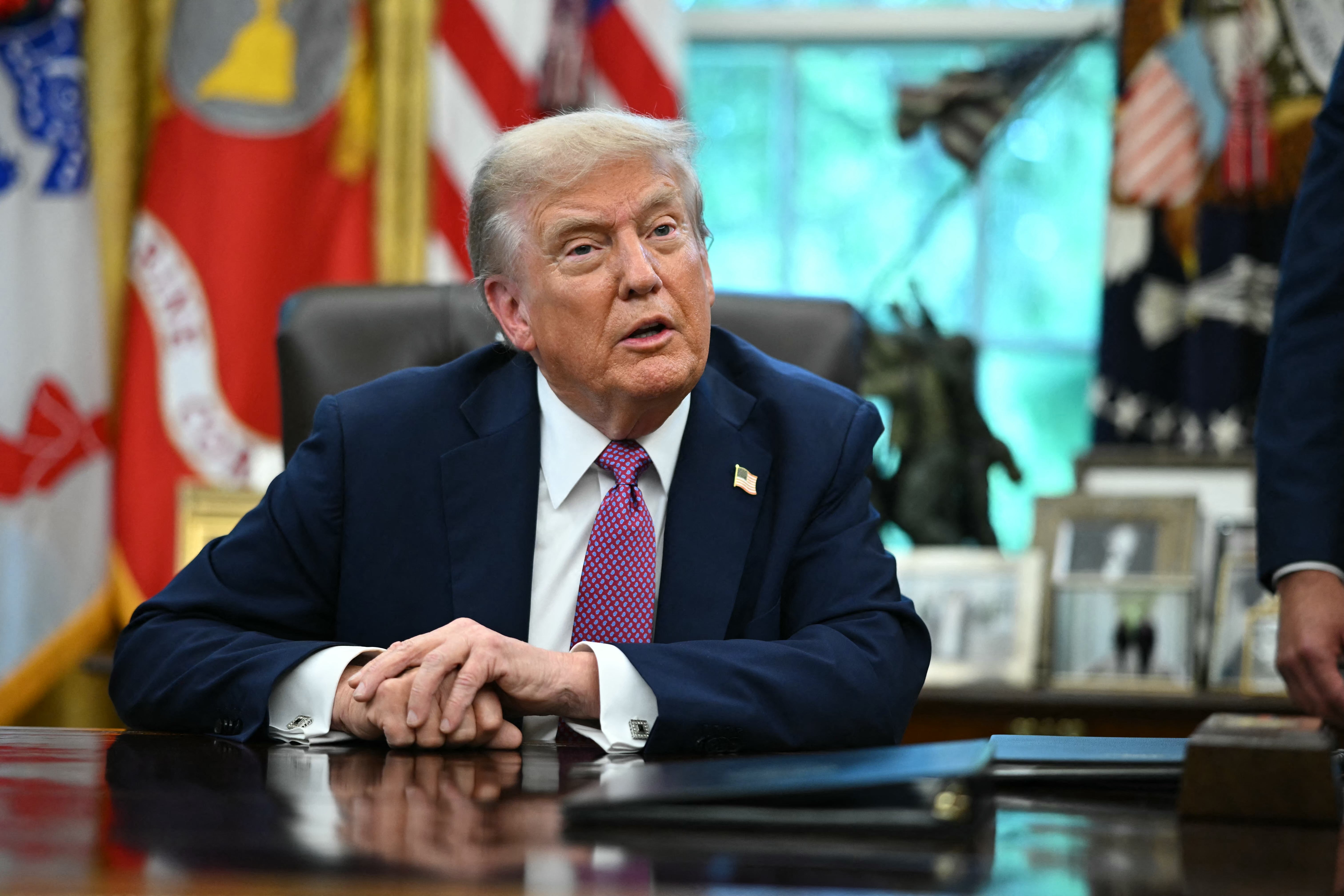 President Donald Trump tried to downplay a bizarre social media post he made that seemed to threaten “war” in Chicago.