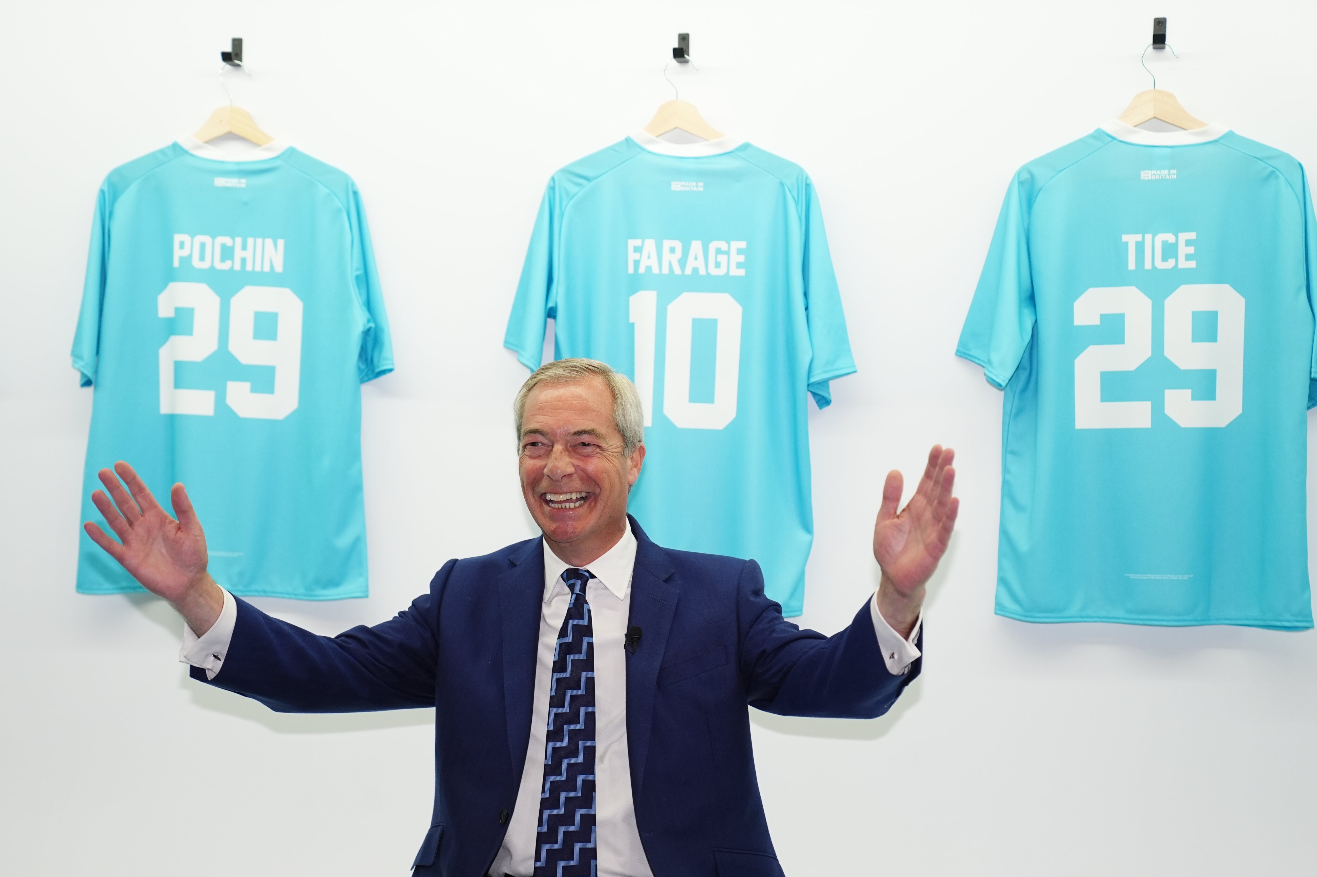 <p>Reform UK leader Nigel Farage in front of football shirts during the party’s annual conference (Jacob King/PA)</p>
