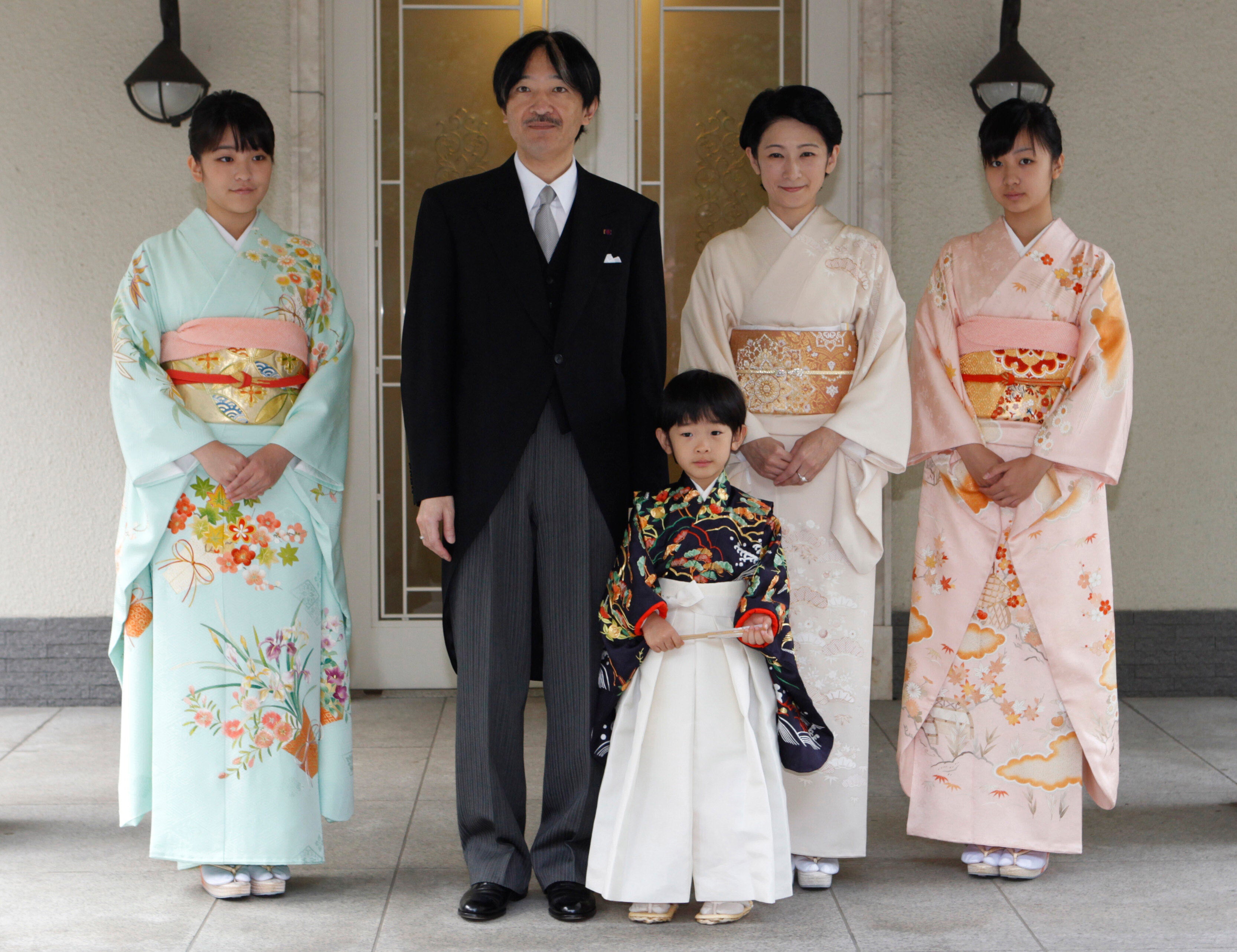 Japan's Prince Hisahito, wearing traditional ceremonial attire, is accompanied by his parents, Prince Akishino, Princess Kiko, his sisters Princess Mako, left, and Princess Kako, right, after attending a 