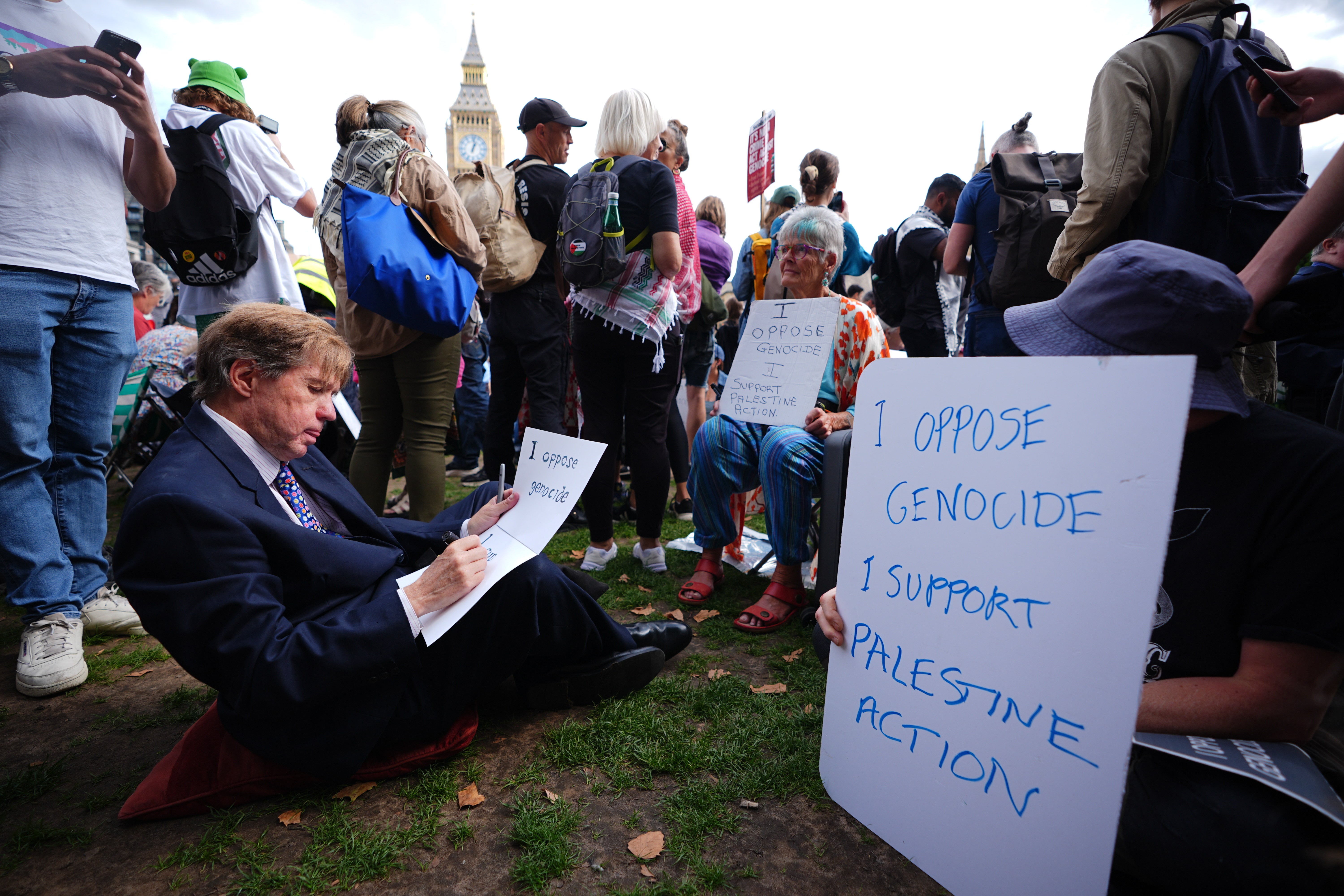 Protesters wrote signs in London's Parliament Square before police started making arrests