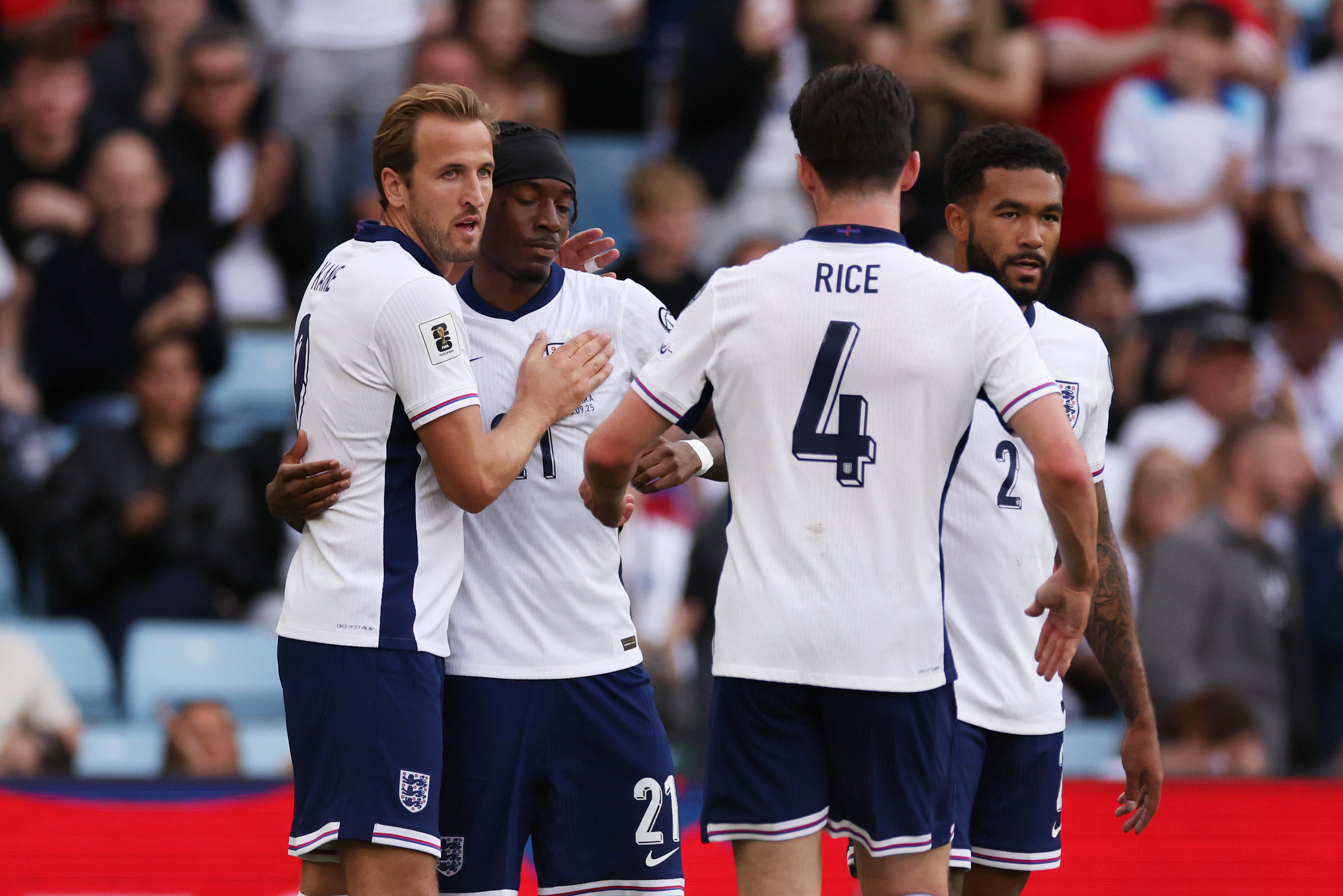 Harry Kane and Noni Madueke of England celebrate their side's first goal, an own goal by Christian Garcia of Andorra
