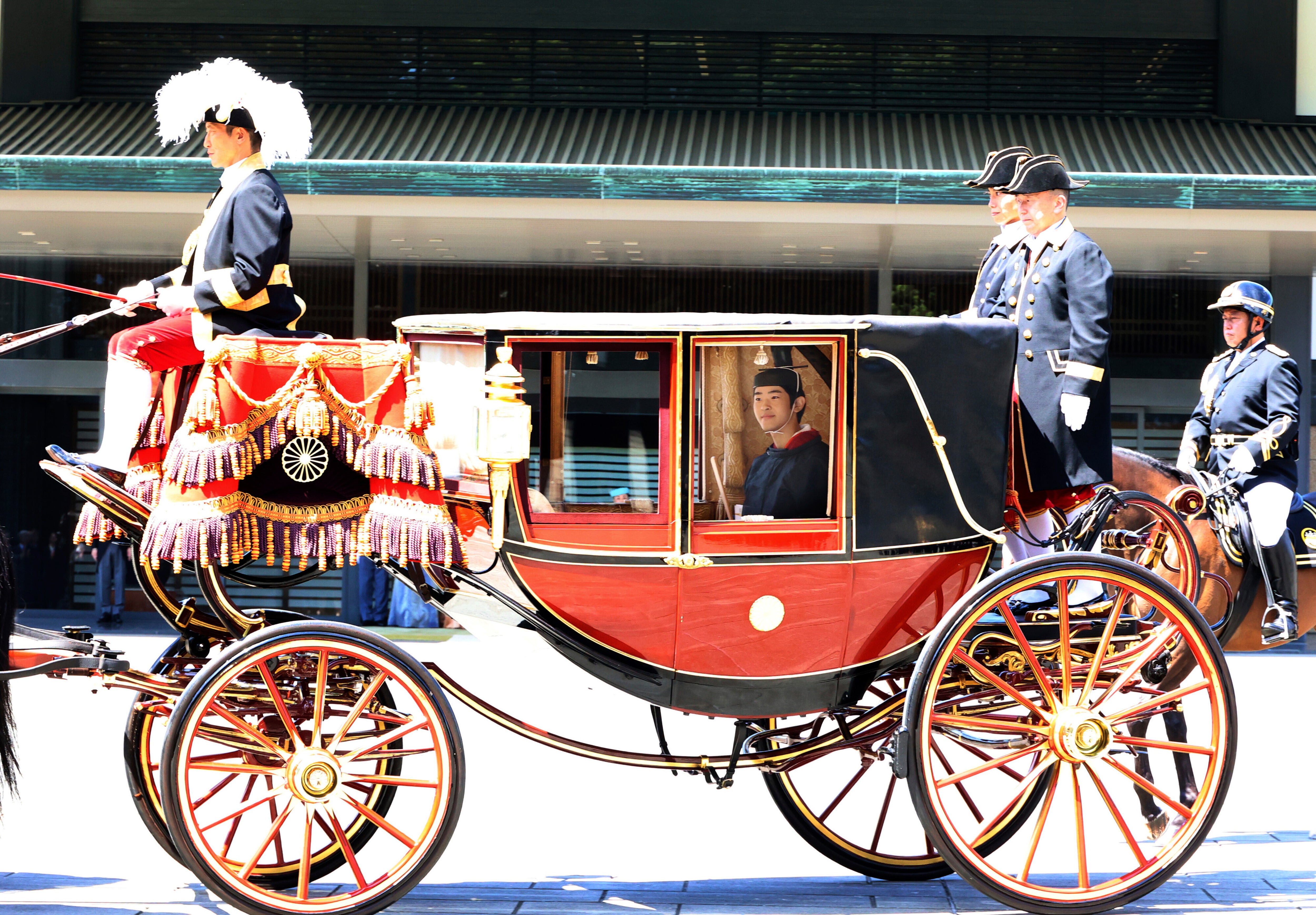 Japanese Prince Hisahito, son of Crown Prince Akishino, wearing ancient ceremonial costume, leaves for a ceremony by a carriage at the Imperial Palace in Tokyo
