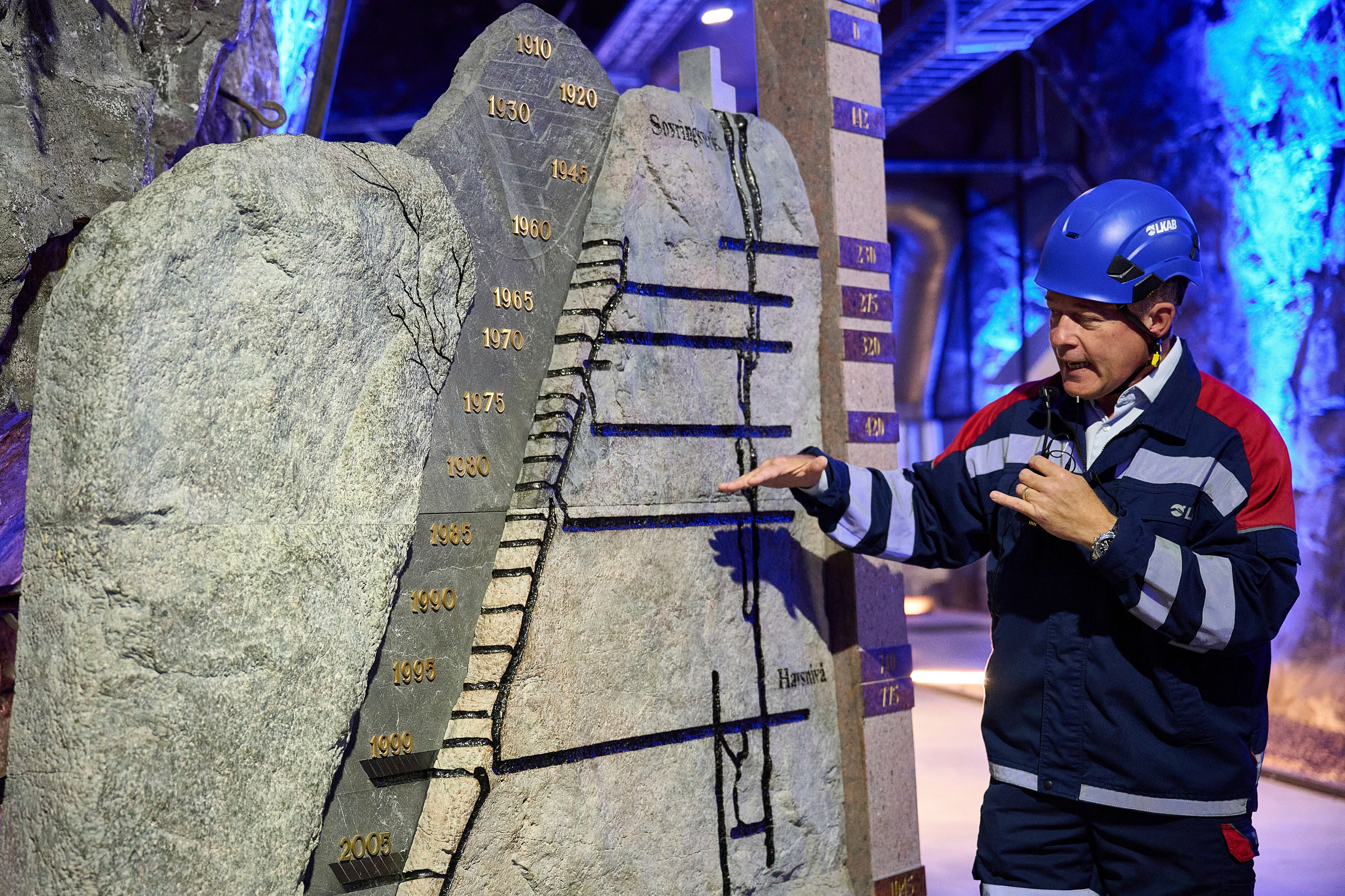 Darren Wilson, LKAB's senior vice president of special products, gestures next to a model of existing mines, in Kiruna, Sweden, Monday, Aug. 18, 2025. (AP Photo/Malin Haarala)