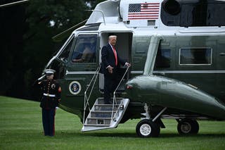 US President Donald Trump boards Marine One as he departs from the South Lawn of the White House in Washington, DC