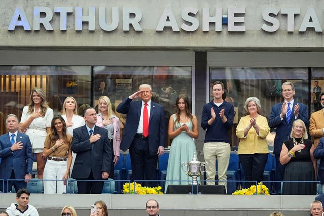 <p>President Donald Trump, centre, salutes during the national anthem (Manuel Balce Ceneta/AP)</p>