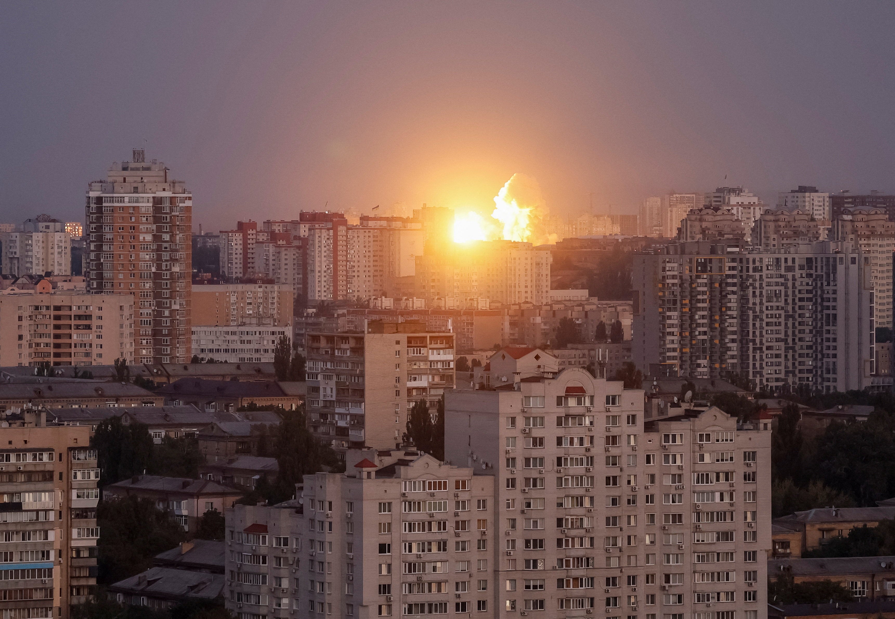 An explosion of a missile lights up the sky during a Russian strike in Kyiv