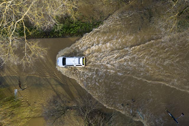 A car drives through floodwater at the Billing Aquadrome in Northamptonshire last November. (Jordan Pettitt/PA)
