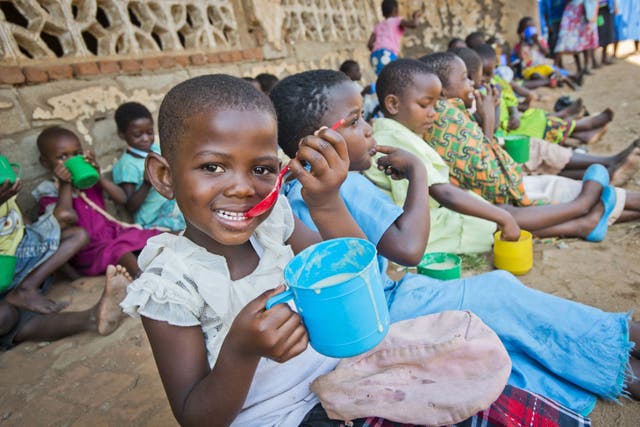 School pupils in Malawi eating porridge provided by Mary’s Meals (Chris Watt/Mary’s Meals/PA)
