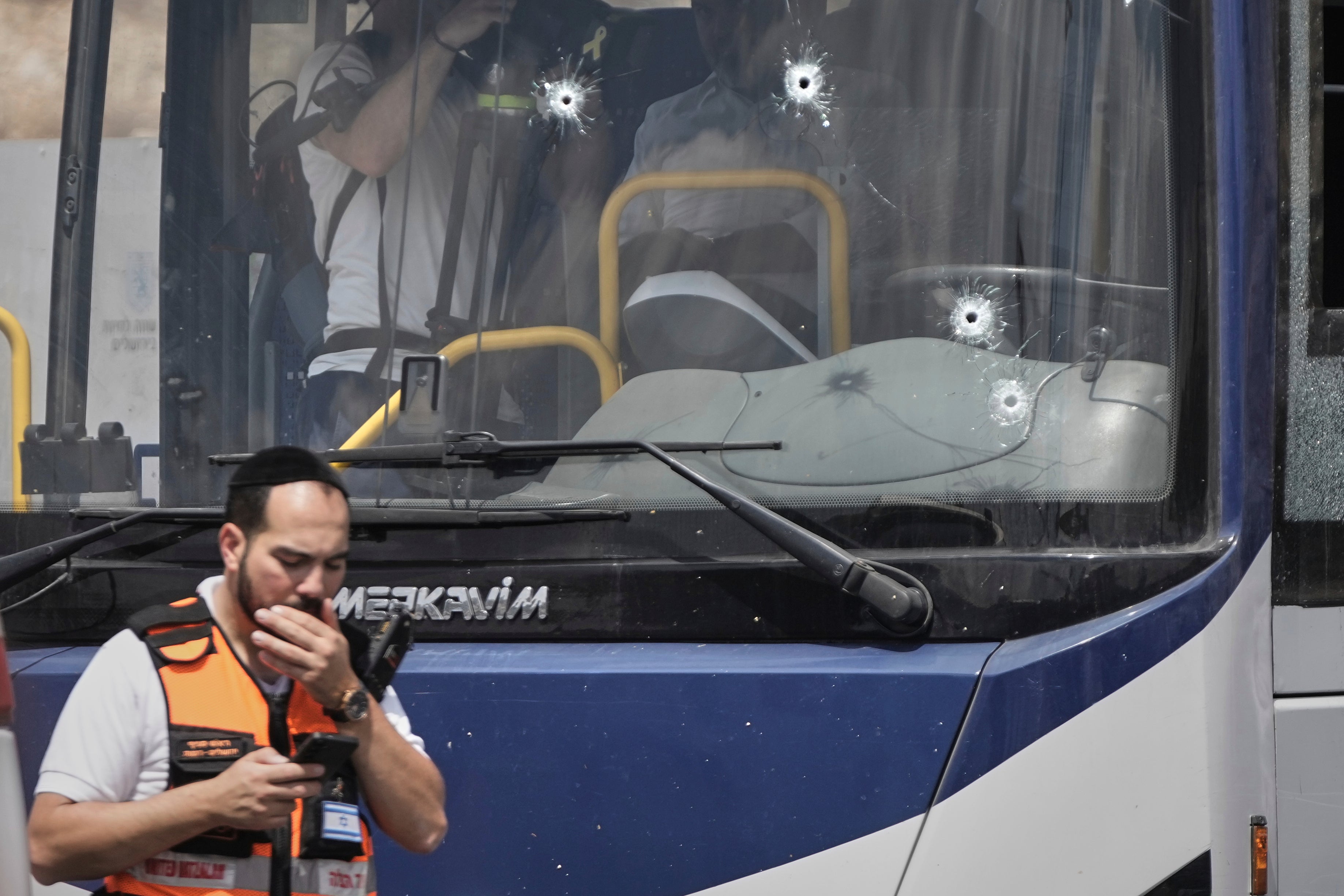 Israeli police and rescue teams inspect the scene of a shooting attack