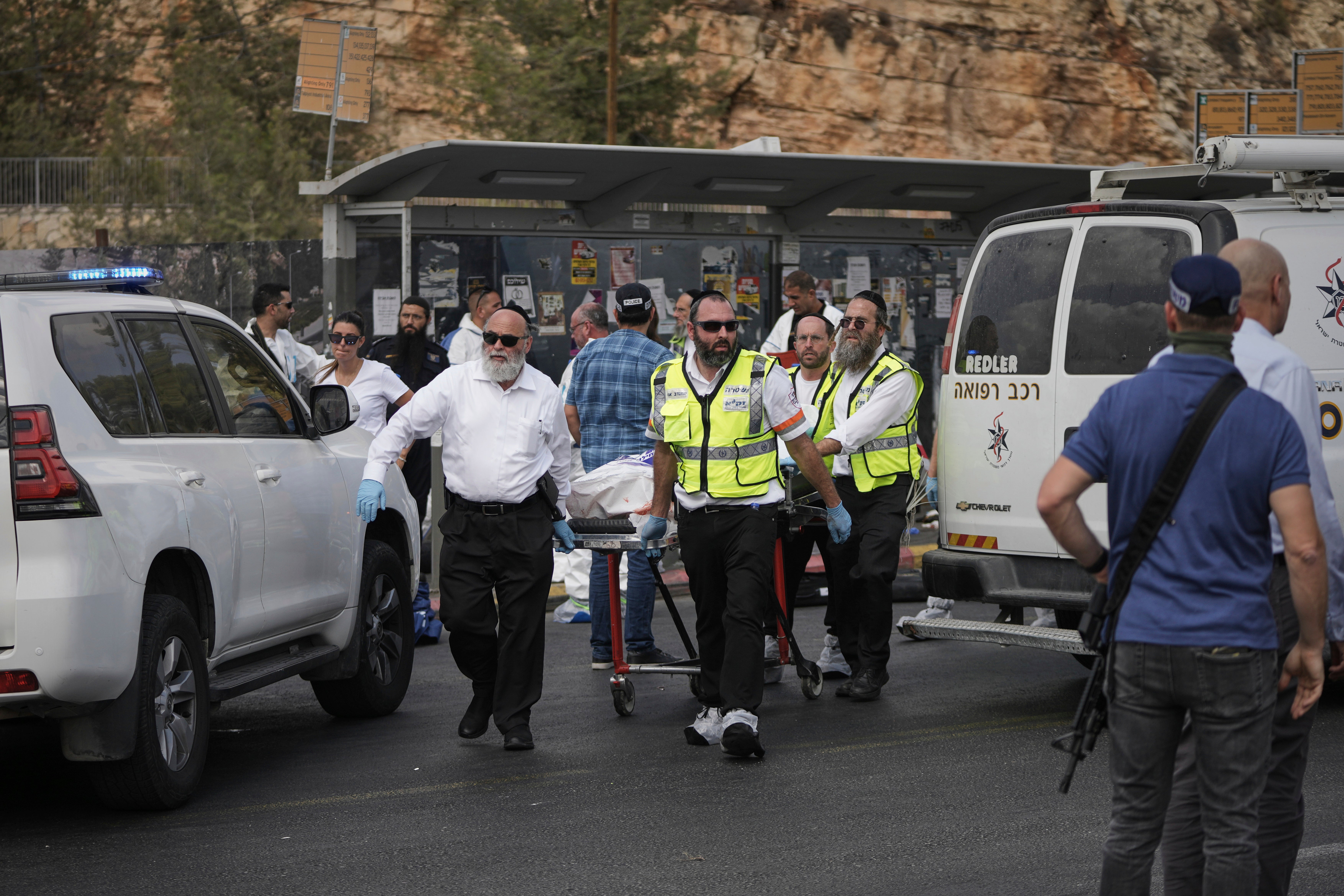 Israeli Zaka rescue and recovery team carry the body of a victim