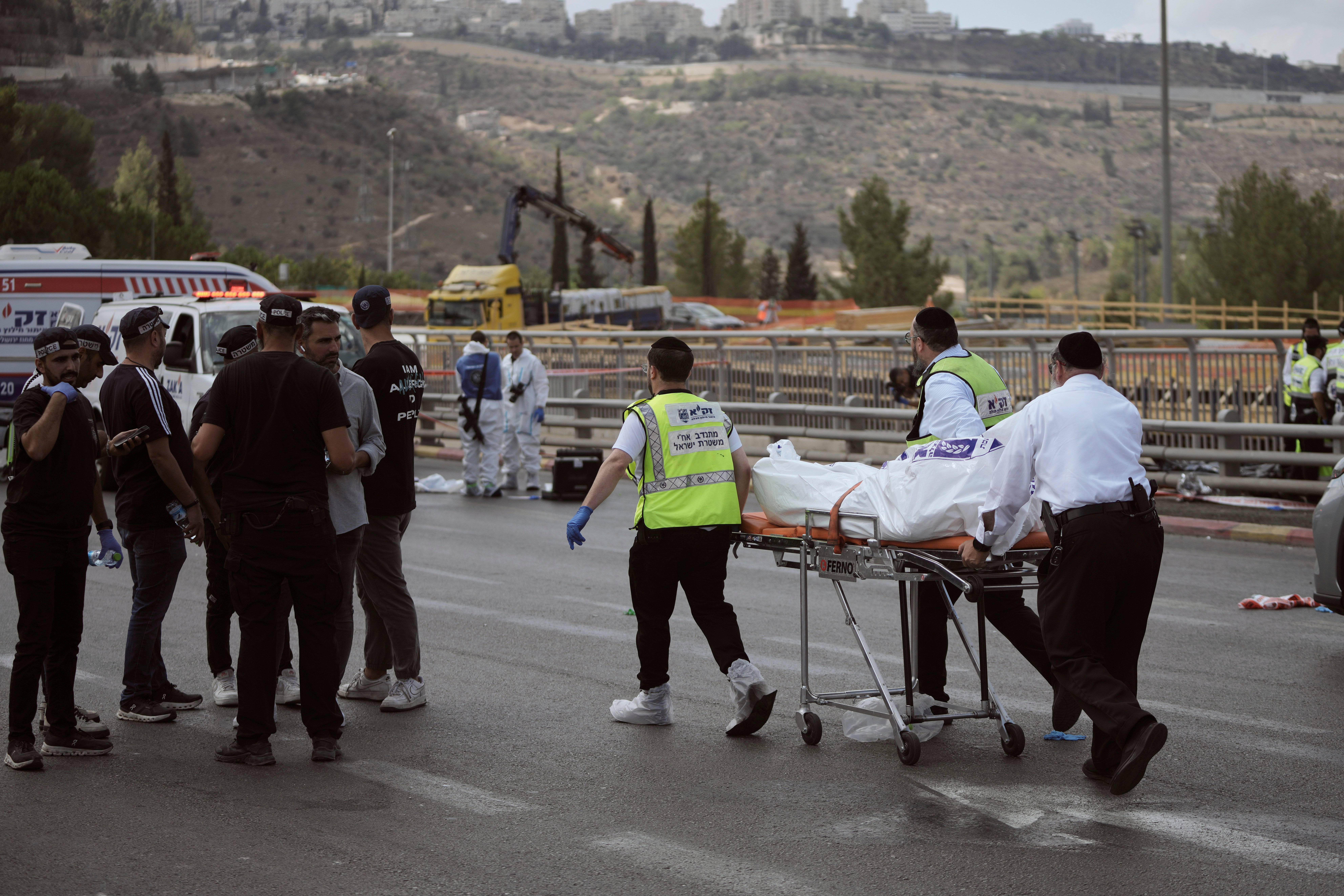 Israeli Zaka rescue and recovery team carry the body of a victim