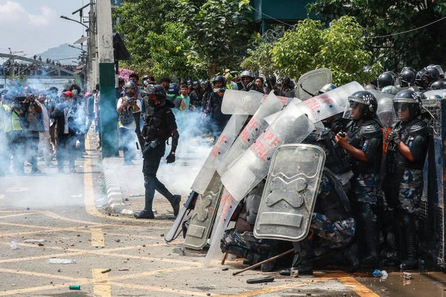 <p>Riot police personnel stand guard during a protest</p>