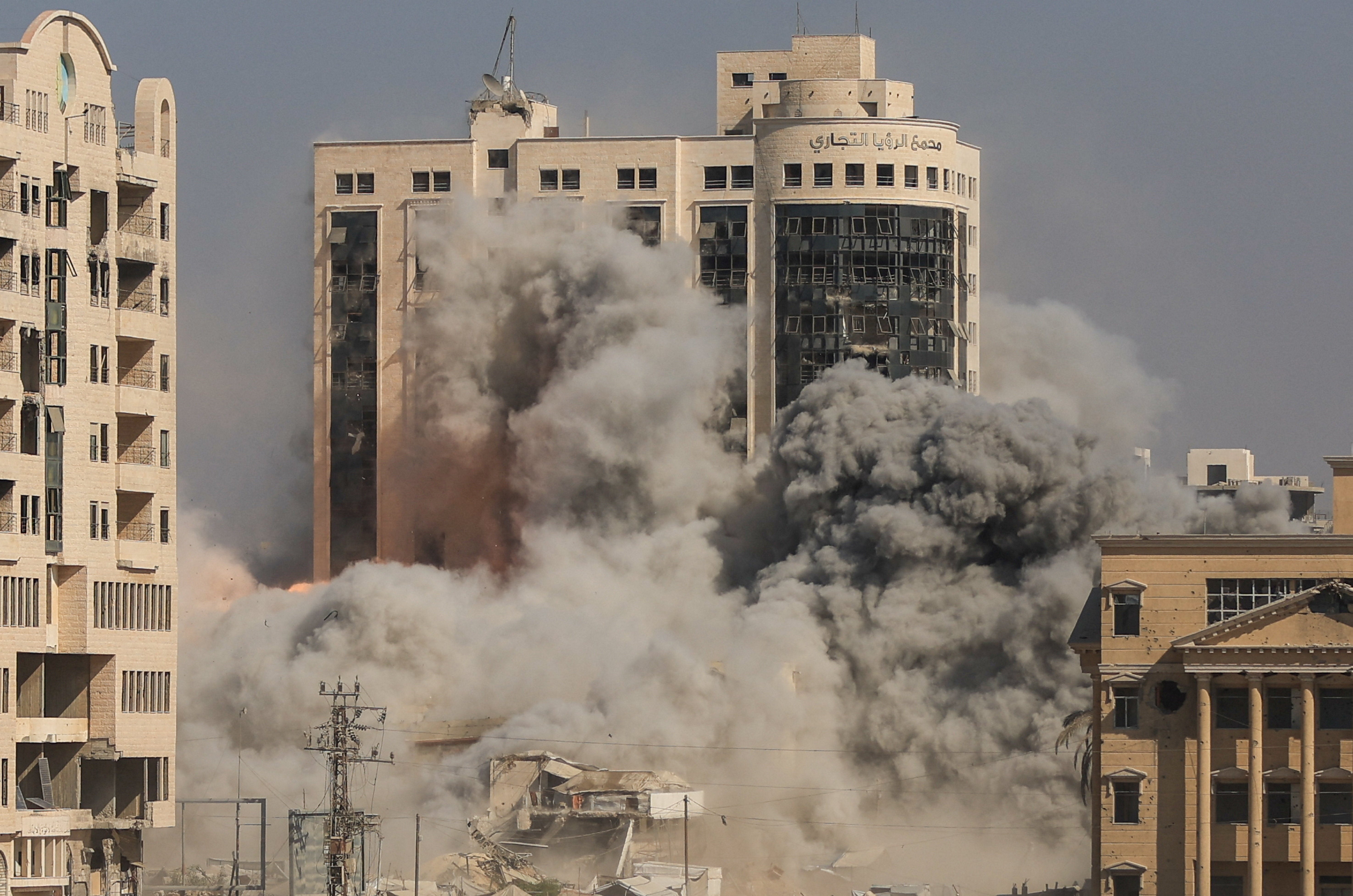 Smoke and flames rise as a residential building collapses after an Israeli air strike, in Gaza City, 8 September