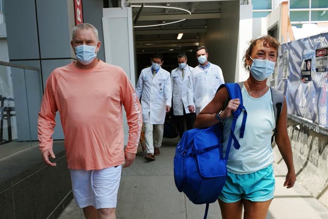 <p>Bill Stewart, left, leaves the hospital with his wife, Sara, after being discharged at Massachusetts General Hospital in Boston</p>