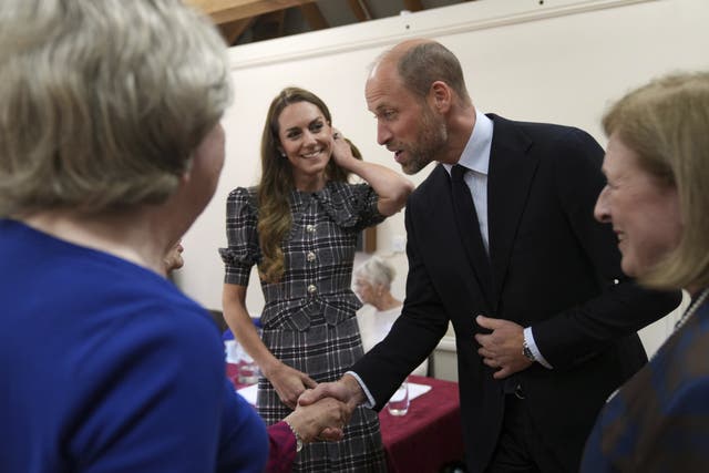 The Prince and Princess of Wales are welcomed by members to the Sunningdale branch of the WI (Alastair Grant/PA)