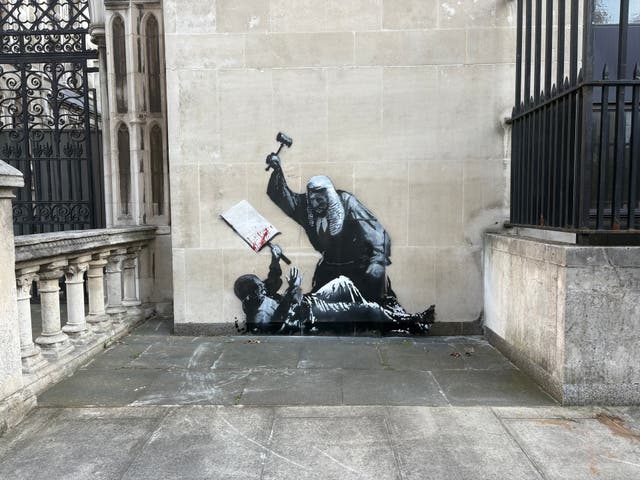 <p>Banksy could finally see his identity revealed after police launched an investigation into his latest artwork at the Royal Courts of Justice in London</p>