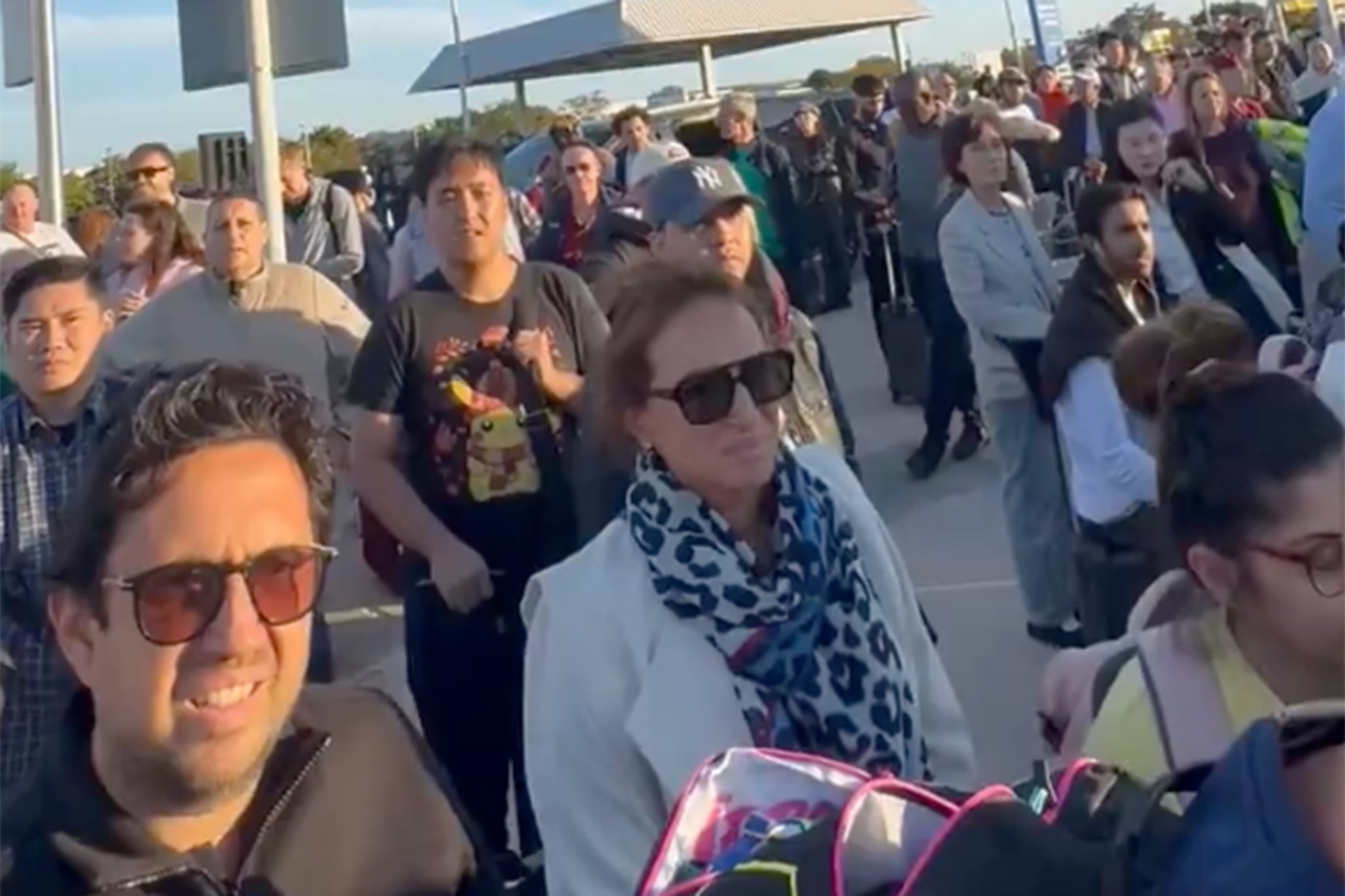 Terminal 4 travellers stood outside the airport