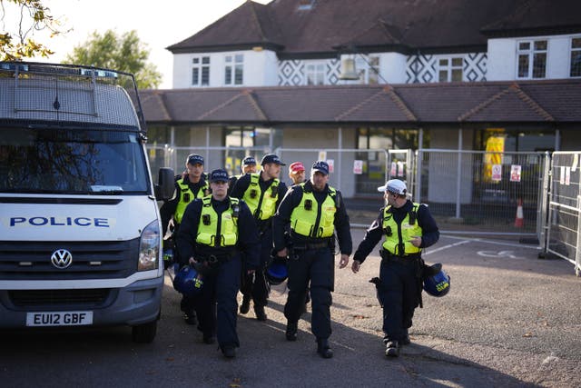 <p>Police outside the Bell Hotel in Epping which faced protests over housing asylum seekers</p>