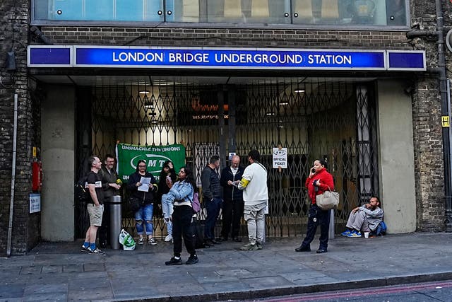 <p>Members of RMT man an official picket line outside one of the closed entrances to London Bridge Underground in London on Monday</p>