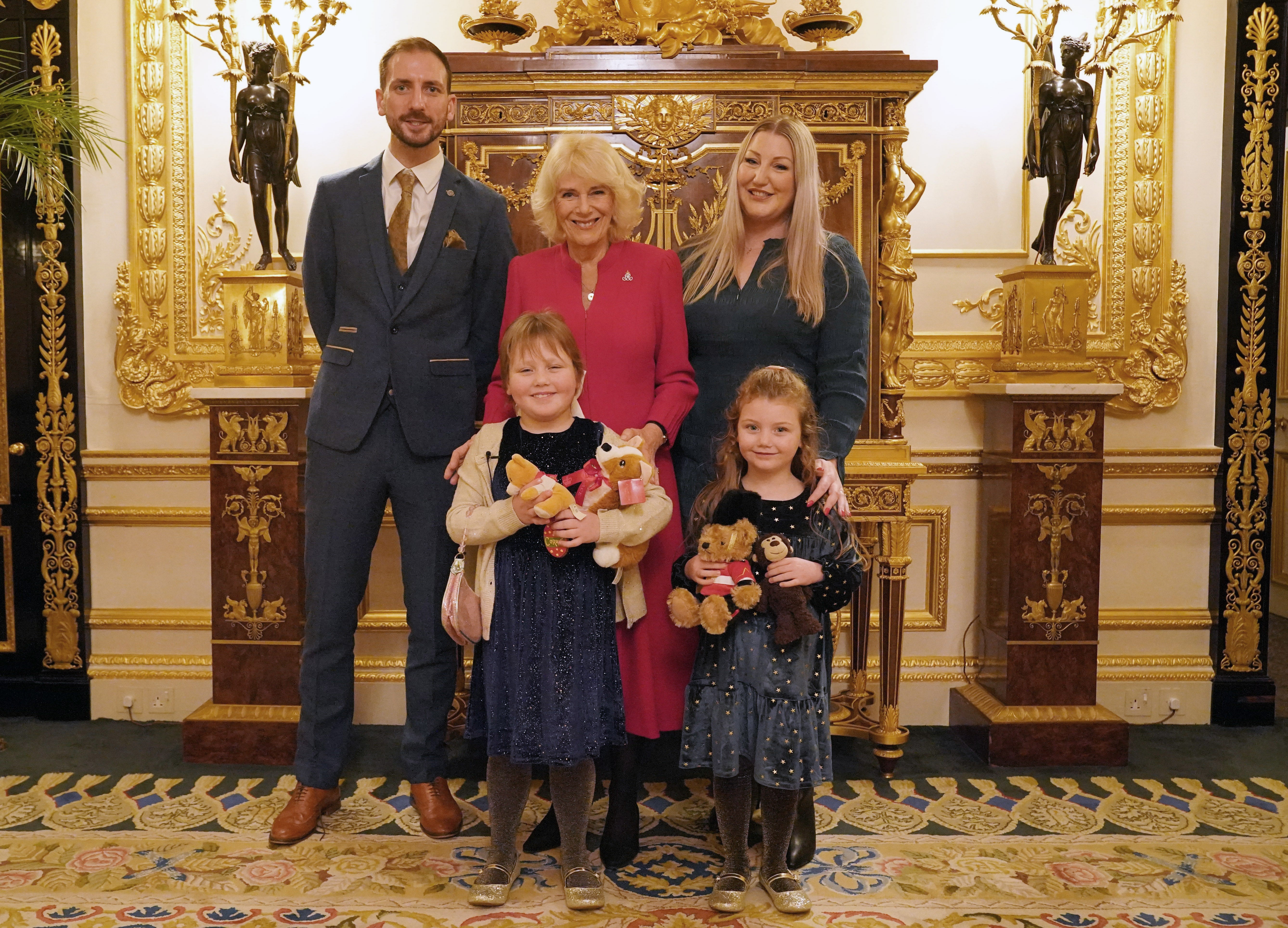 Queen Camilla with Olivia (front left), her sister Imogen (front right), father Matthew (back left) and mother Lisa (back right)