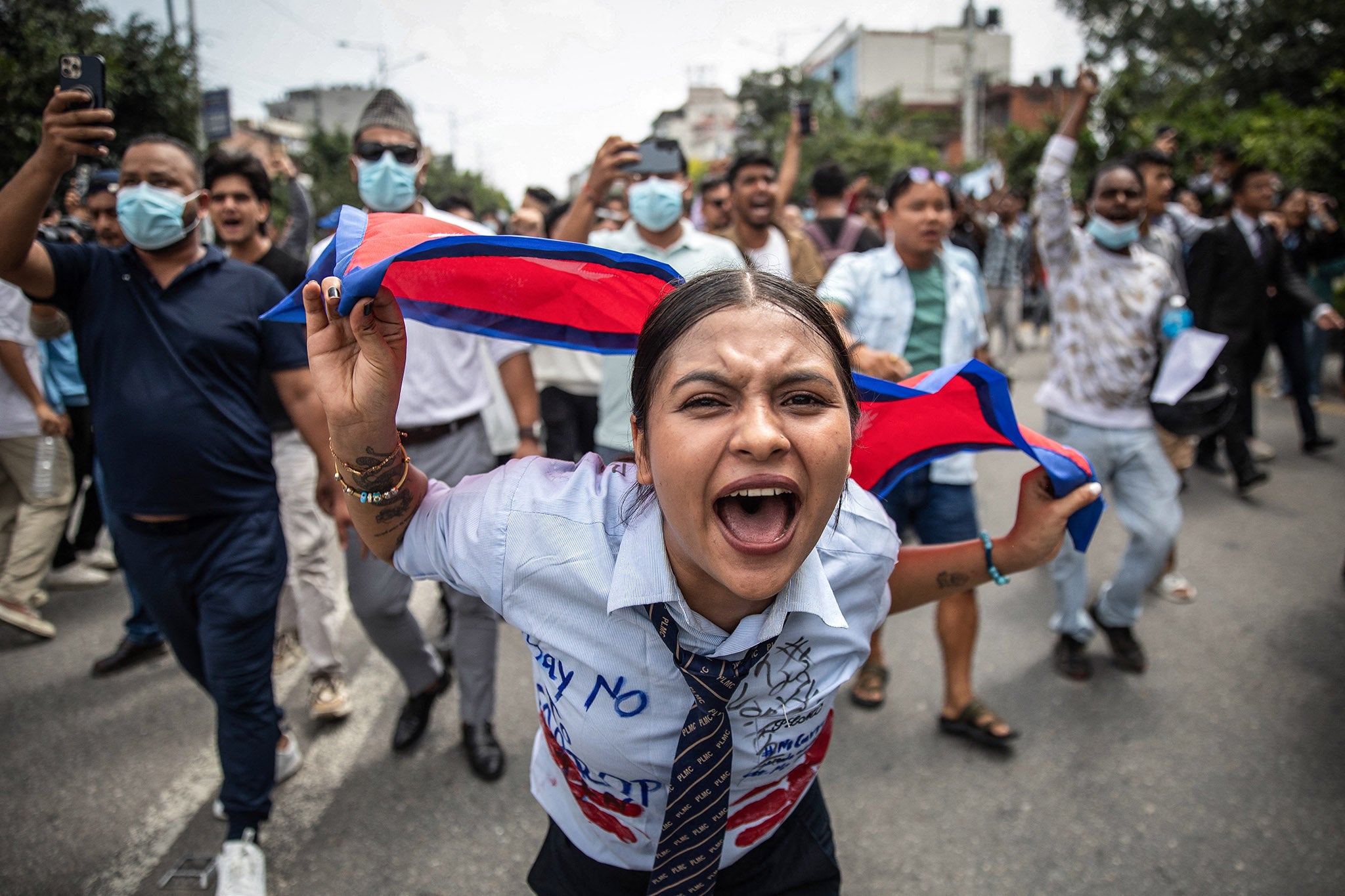A protester shouts slogans outside the parliament in Kathmandu