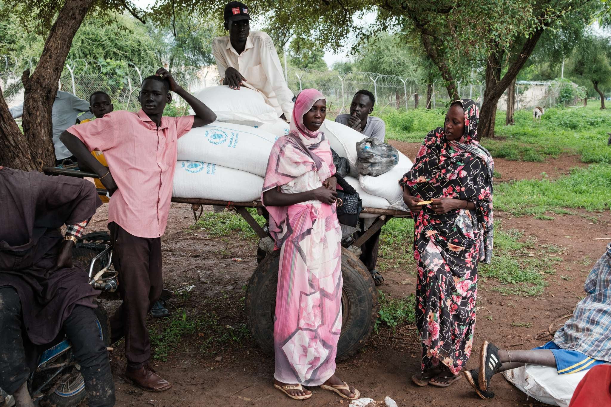 <p>People wait outside a food distribution site in Maban, South Sudan</p>