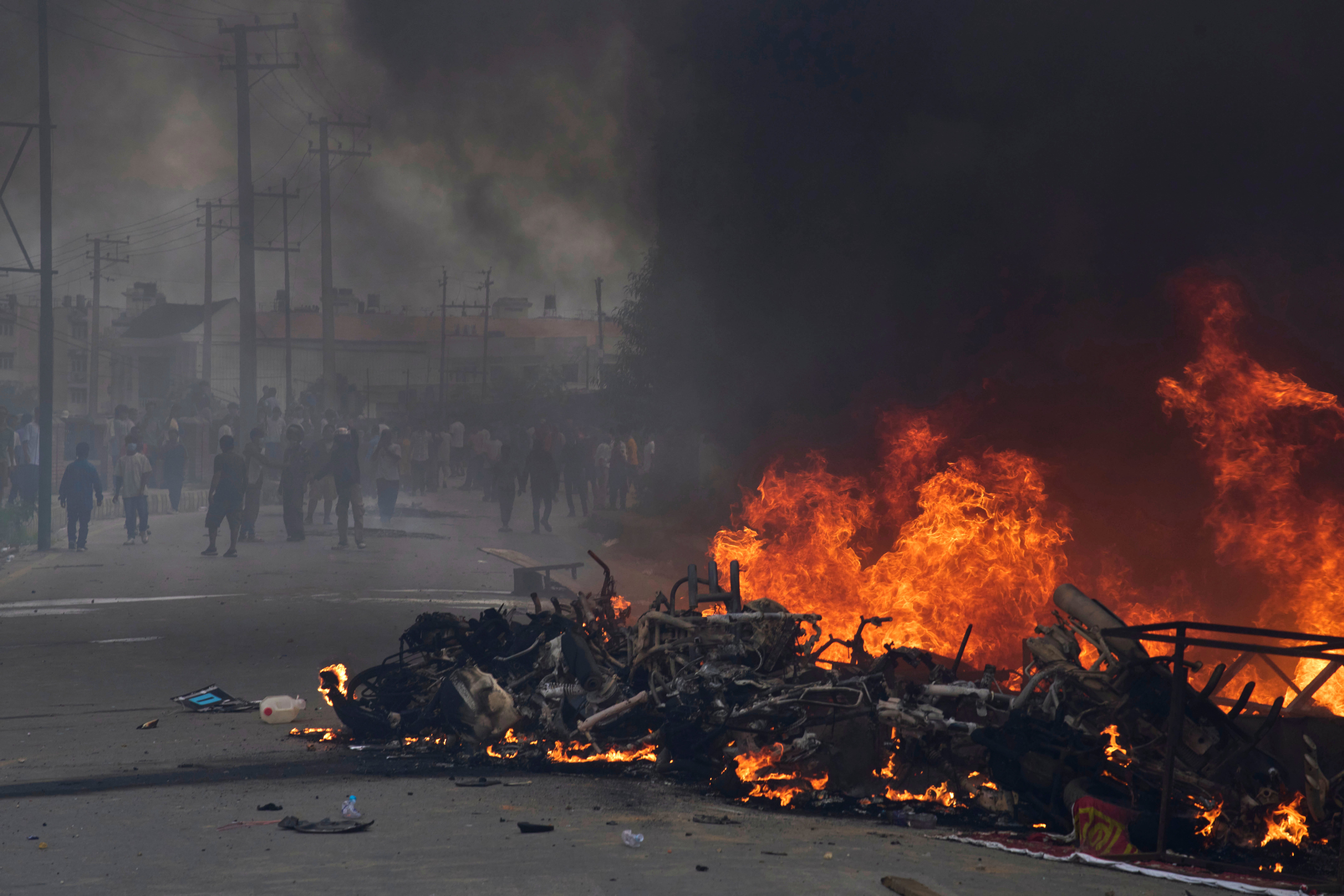 Protesters burn vehicles and tires during protests against social media ban and corruption in Kathmandu, Nepal, Tuesday, 9 September