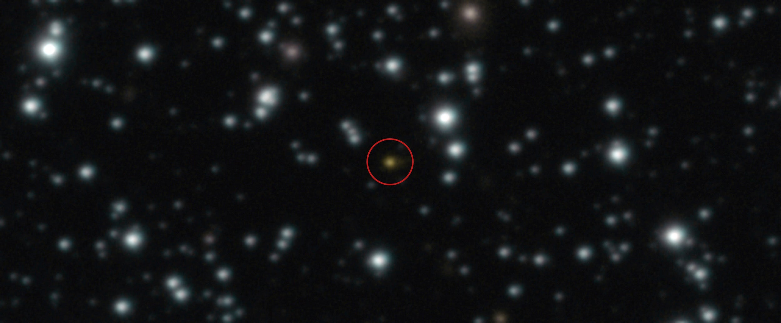 This image provided by the European Southern Observatory shows a powerful explosion, orange dot at the center of the image, that repeated several times over the course of a day, The image, taken with ESO's Very Large Telescope (VLT), allowed astronomers to determine that the explosion didn't take place in the Milky Way but in another galaxy