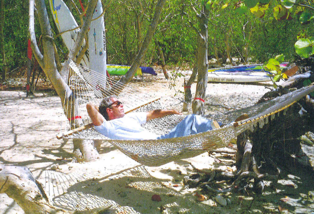 <p>Jeffrey Epstein lounges in a hammock in a picture included in a book gifted to him to celebrate his 50th birthday. The House Oversight Committee released the book on Monday night after a subpoena to the late pedophile’s estate</p>