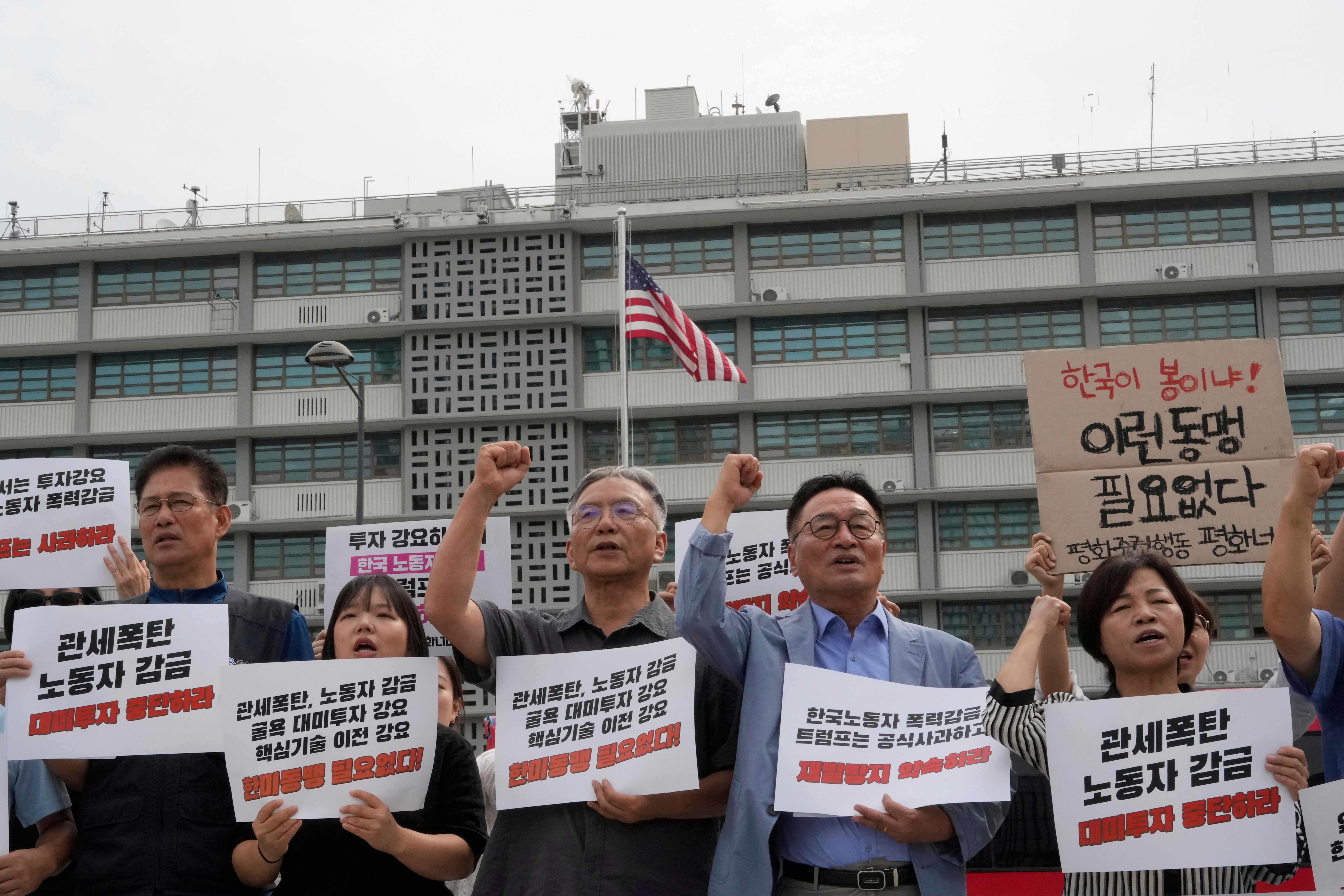 Protesters stage a rally against the detention of South Korean workers during an immigration raid in Georgia, near the U.S. Embassy in Seoul, South Korea, this week. The signs read ‘A tariff bomb and workers confinement’